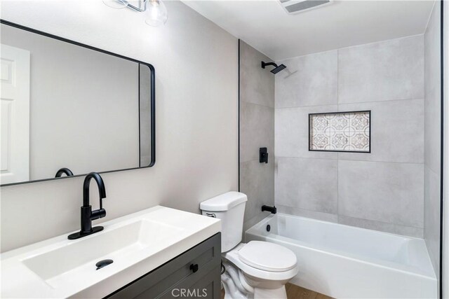 full bathroom featuring vanity, toilet, and tiled shower / bath