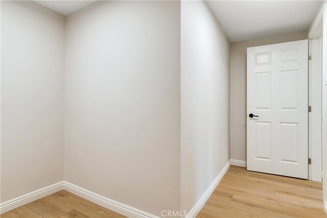 hallway with light hardwood / wood-style floors