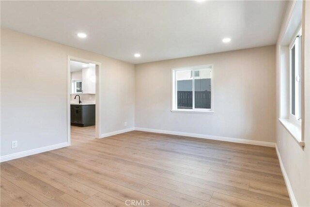 spare room featuring light hardwood / wood-style flooring and sink