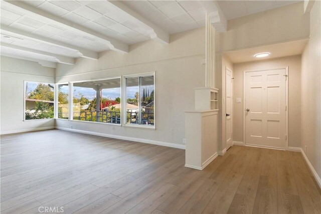 entrance foyer featuring hardwood / wood-style flooring and beam ceiling