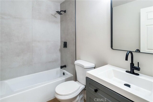 full bathroom with vanity, toilet, and tiled shower / bath combo