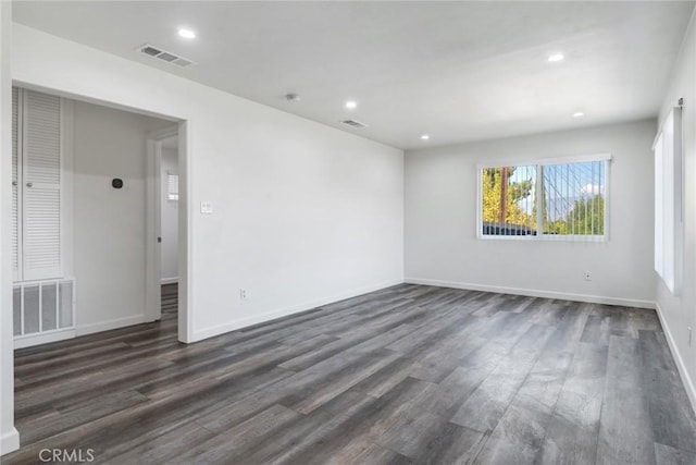 spare room with dark hardwood / wood-style floors