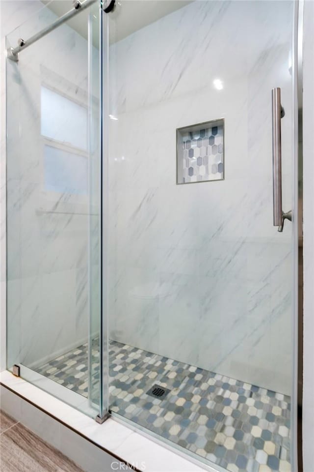 bathroom with a shower with shower door