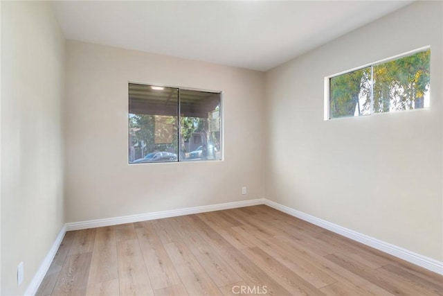 spare room featuring light hardwood / wood-style floors