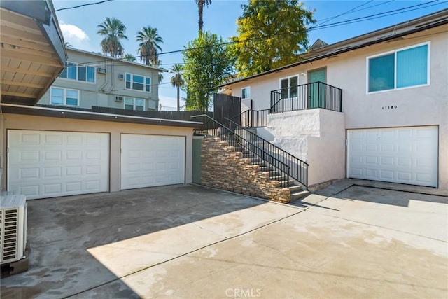 view of front of property with ac unit and a garage