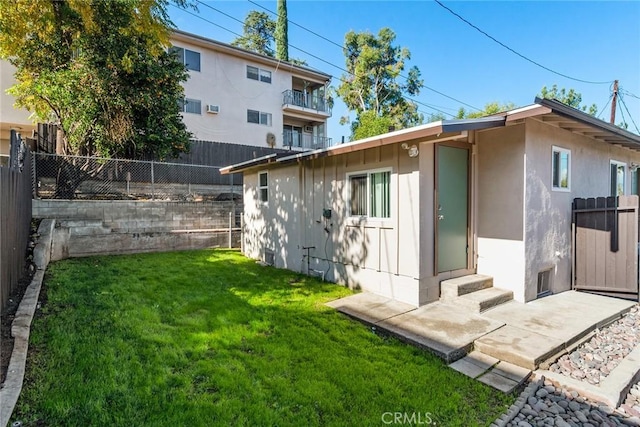 back of house with a lawn