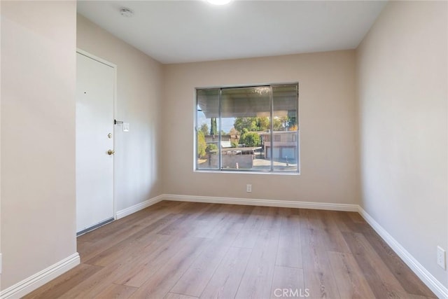 spare room with light hardwood / wood-style flooring