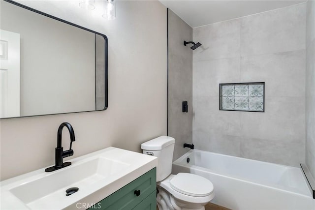 full bathroom with toilet, vanity, and tiled shower / bath