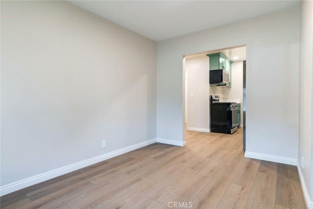 empty room with light hardwood / wood-style flooring