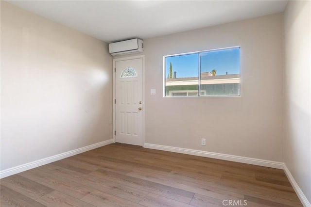 foyer featuring a wall mounted air conditioner and light wood-type flooring