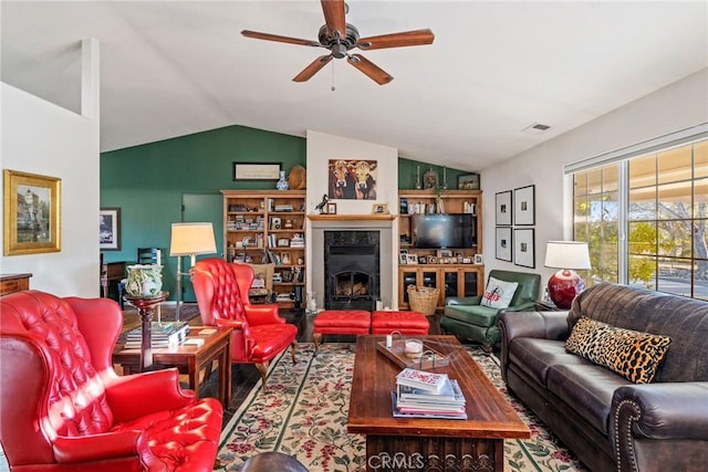 living room featuring ceiling fan and vaulted ceiling