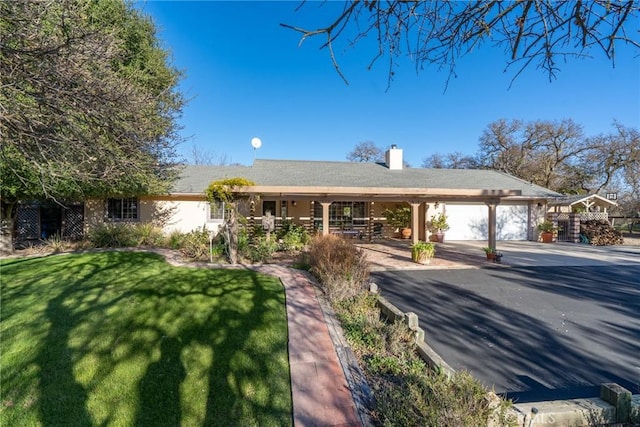 ranch-style house featuring a garage and a front lawn