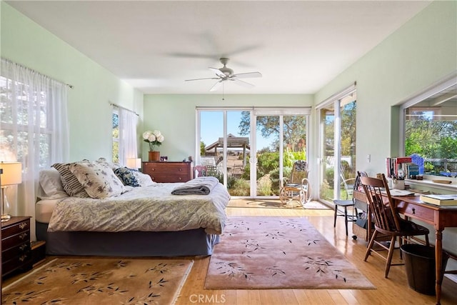 bedroom with ceiling fan, access to exterior, and light hardwood / wood-style flooring