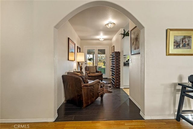 hallway with hardwood / wood-style flooring