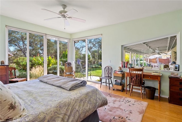 bedroom with light wood-type flooring, access to outside, and ceiling fan