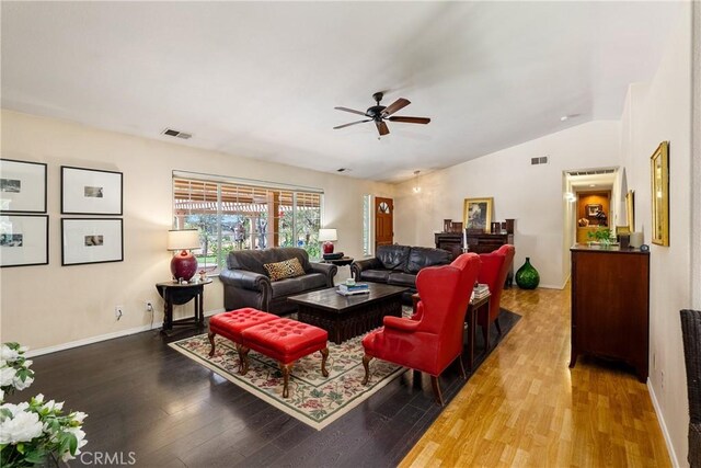 living room with hardwood / wood-style floors, vaulted ceiling, and ceiling fan