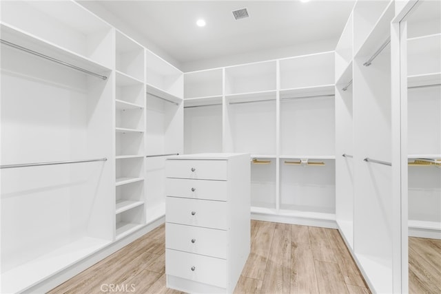 walk in closet with light wood finished floors and visible vents