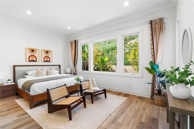 bedroom with recessed lighting, baseboards, crown molding, and light wood finished floors