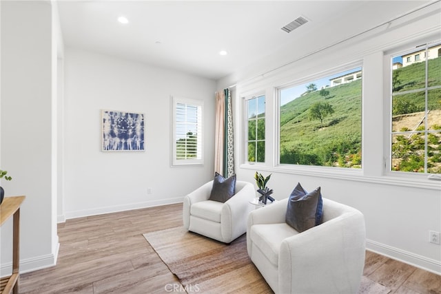 sitting room with recessed lighting, baseboards, visible vents, and light wood finished floors