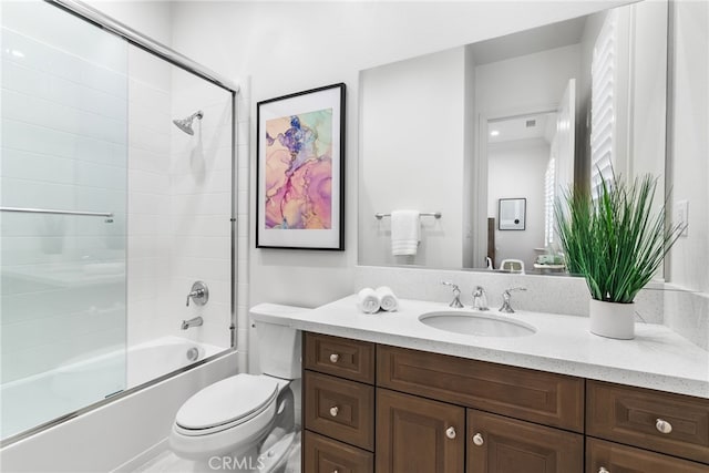 bathroom featuring bath / shower combo with glass door, vanity, and toilet