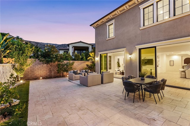 view of patio / terrace with outdoor dining space, a fenced backyard, and an outdoor living space