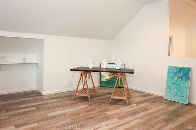 office area featuring hardwood / wood-style flooring and vaulted ceiling