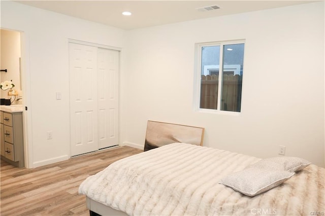 bedroom featuring light wood-type flooring and a closet