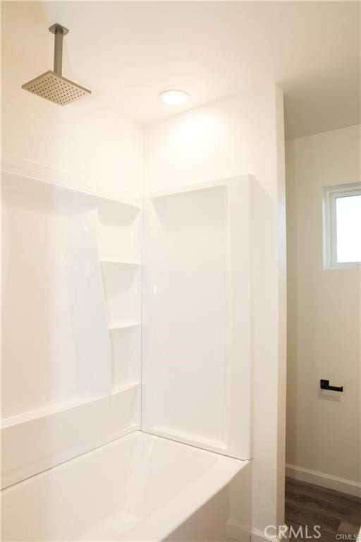 bathroom featuring a shower and hardwood / wood-style floors