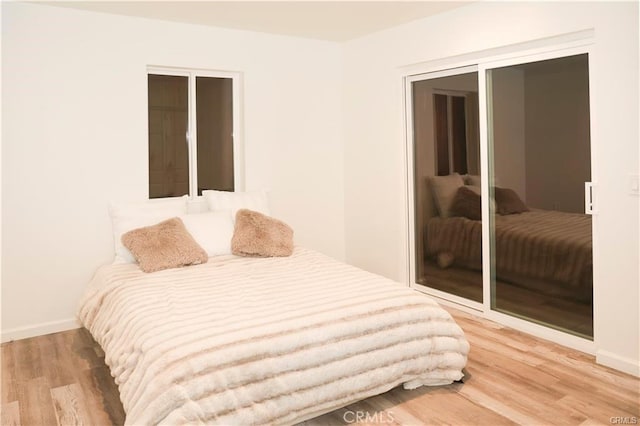 bedroom with a closet and hardwood / wood-style floors