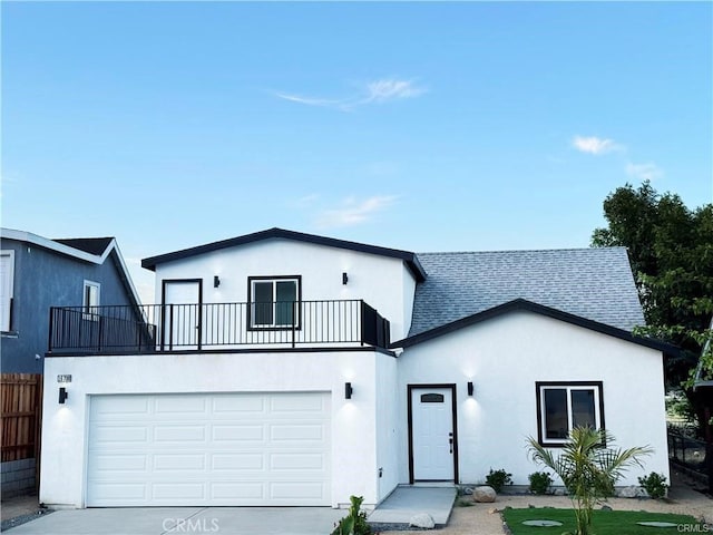 view of front facade with a balcony and a garage