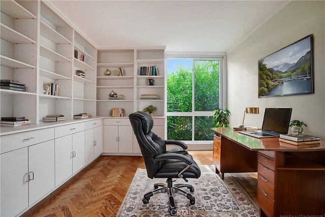 office space featuring dark parquet flooring and crown molding