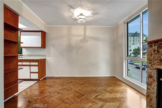 unfurnished dining area with ornamental molding and light parquet floors