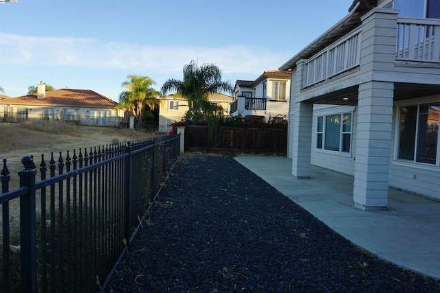 view of yard featuring a balcony and a patio