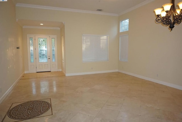 foyer entrance with an inviting chandelier and ornamental molding