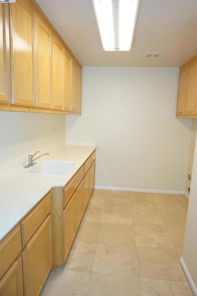 kitchen featuring light brown cabinetry and sink