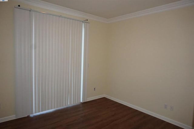 spare room with crown molding and dark hardwood / wood-style flooring