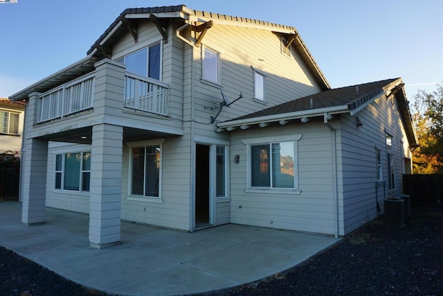 back of house with central AC unit, a patio area, and a balcony