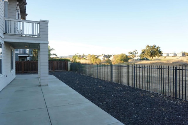 view of yard with a patio area and a balcony