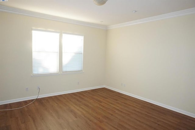 unfurnished room with crown molding and dark wood-type flooring