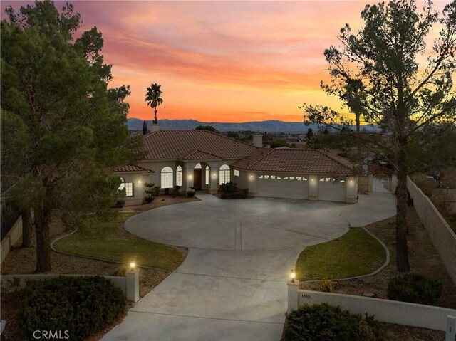 mediterranean / spanish-style home featuring a mountain view and a garage