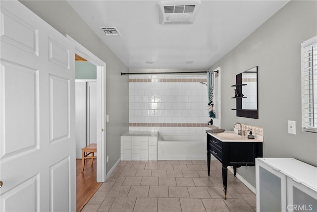 bathroom featuring vanity, bathtub / shower combination, and hardwood / wood-style flooring