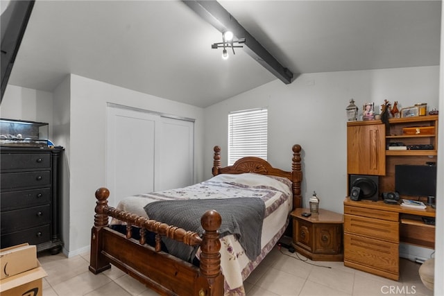 bedroom with vaulted ceiling with beams, a closet, and light tile patterned flooring