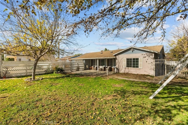 back of property with a patio and a lawn