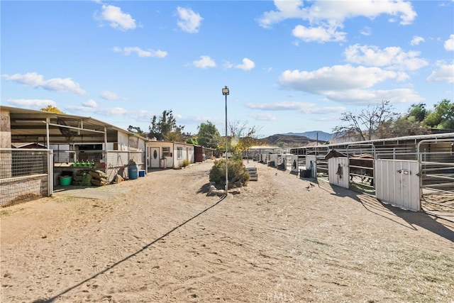 view of yard featuring a mountain view and an outbuilding