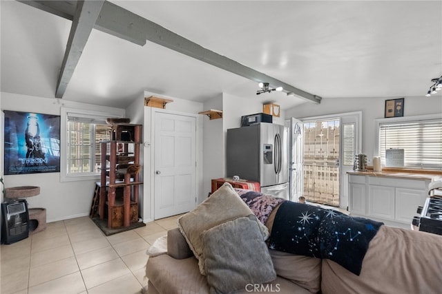 tiled living room featuring vaulted ceiling with beams