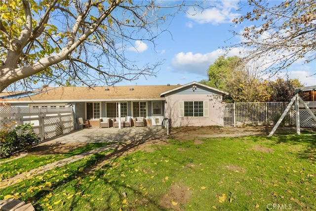 rear view of house featuring a yard and a patio