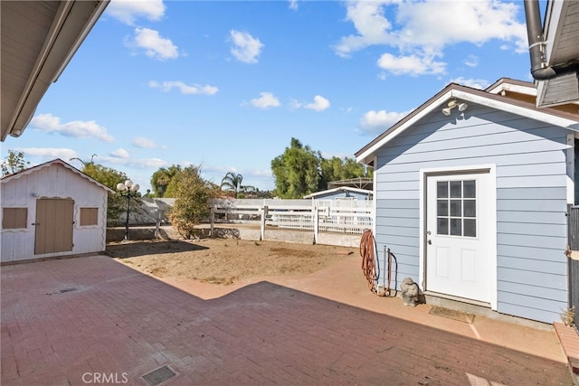 view of yard with a patio and a storage shed