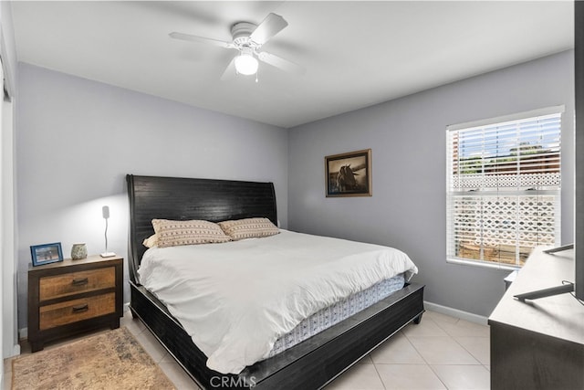 bedroom with ceiling fan and light tile patterned floors