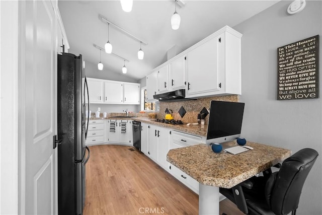 kitchen featuring black appliances, kitchen peninsula, a breakfast bar area, and white cabinetry