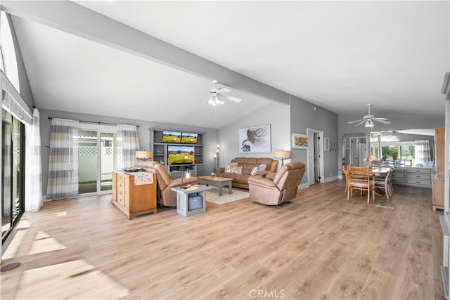 living room with vaulted ceiling with beams, a healthy amount of sunlight, and light hardwood / wood-style flooring